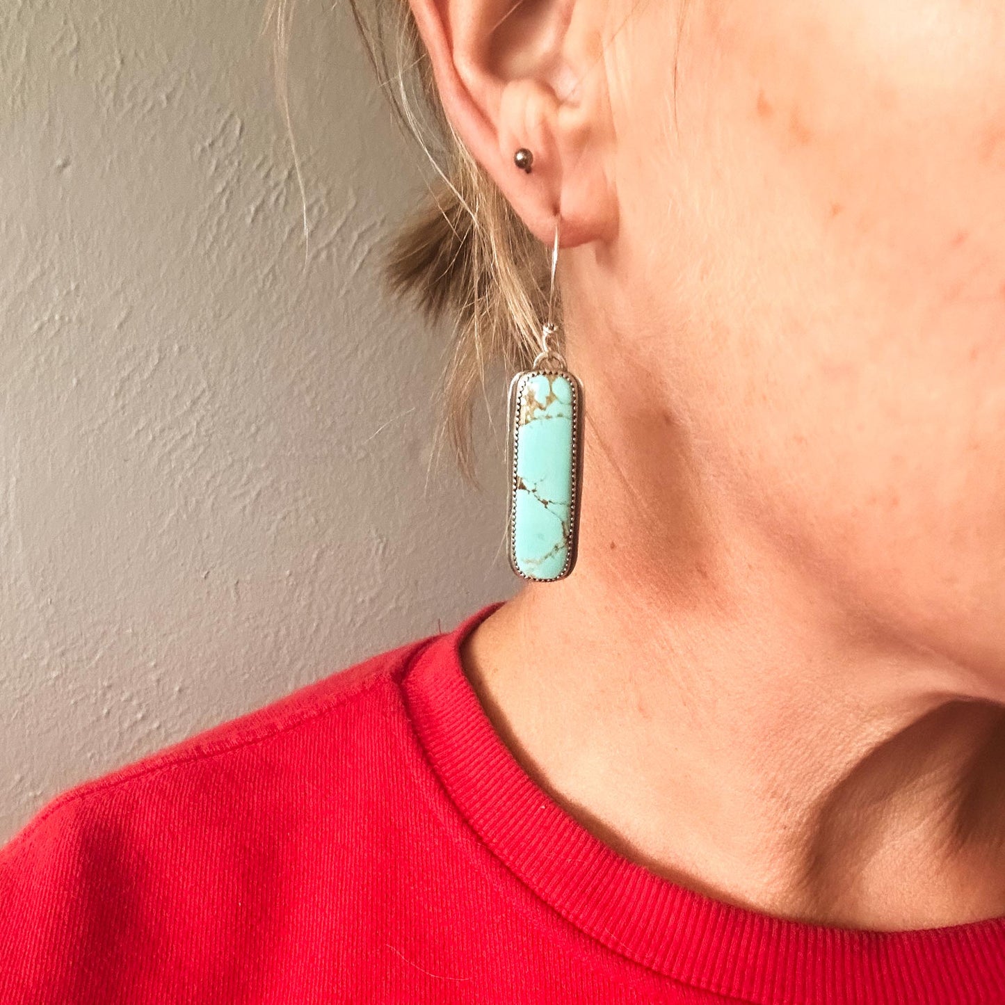 Glacier Blue turquoise vertical bar earrings shown worn for scale, handmade in sterling silver