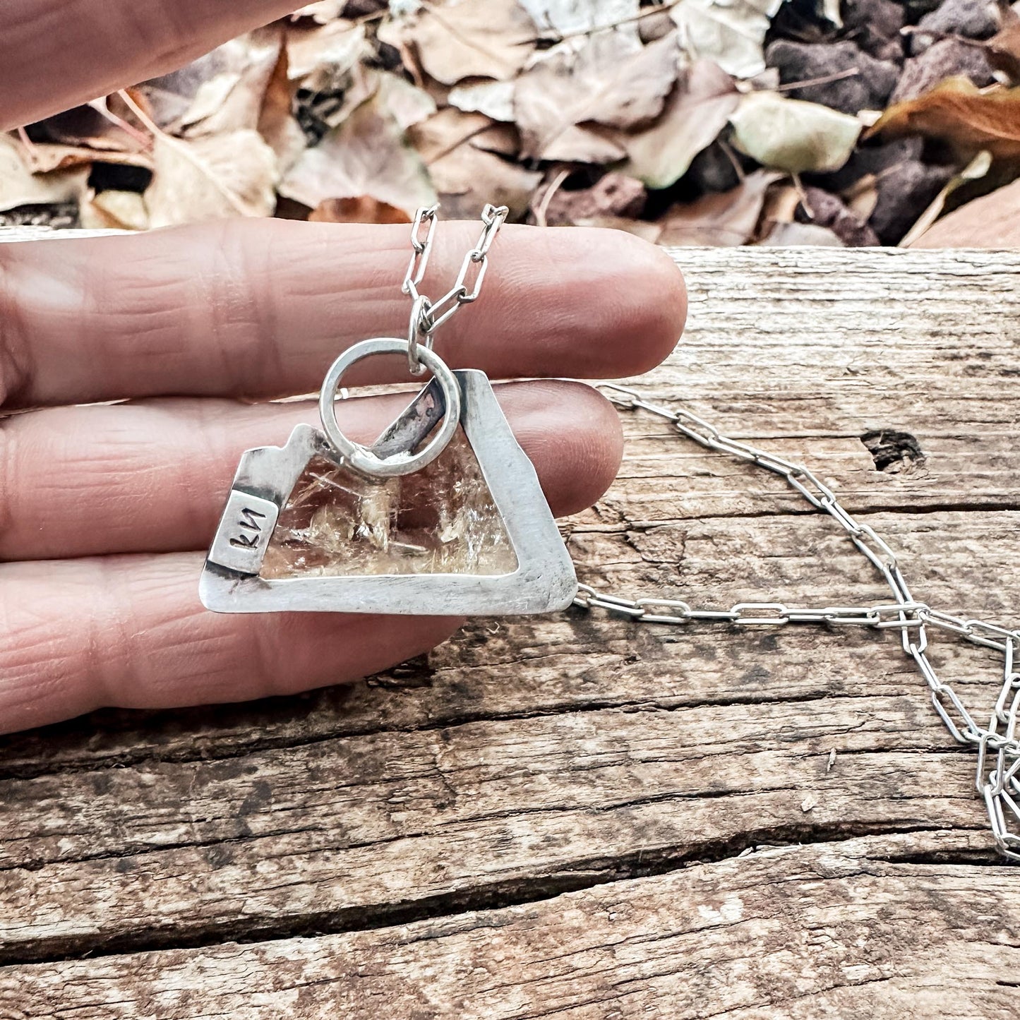 Pendant back is cut out to allow the light to shine through the citrine stone. Makers mark included on back as well. 