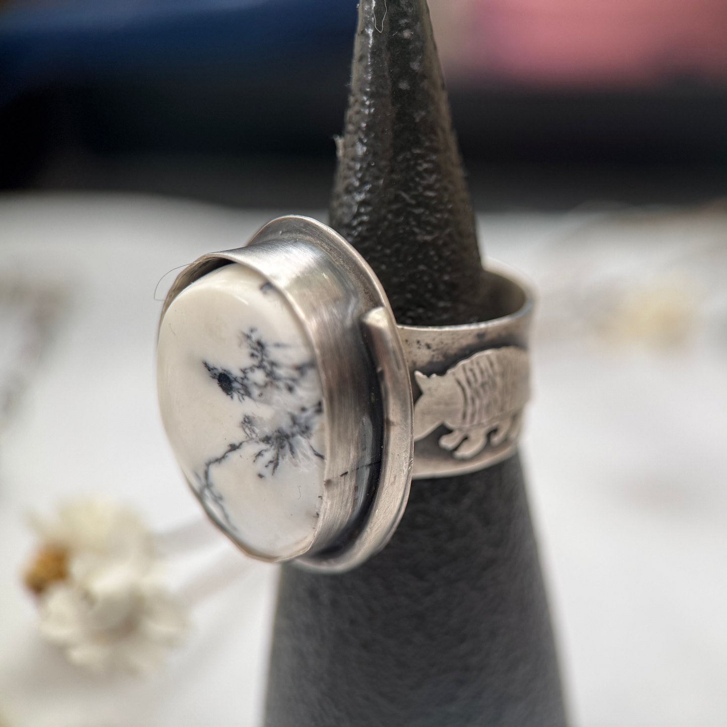 white buffalo stone in sterling silver with wide ring band, armadillo hand-sawed and soldered to one side of band, 