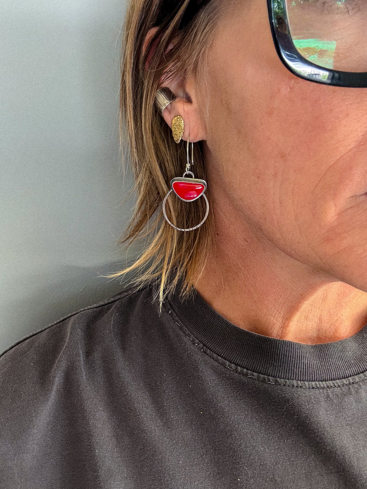 Red Rosarita triangle stones set on sterling silver hoop earrings, 1" in diameter, and 2 1/4" drop length. Worn on right ear in photo.