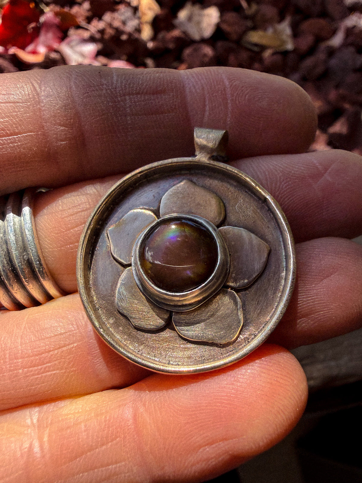 Ethiopian opal set in sterling silver on a bronze flower pendant