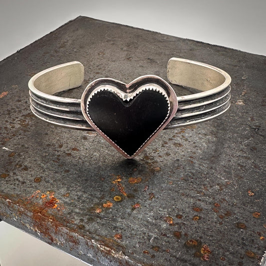 Sterling silver cuff bracelet with matte black jade heart, handmade by Mend Metalworks