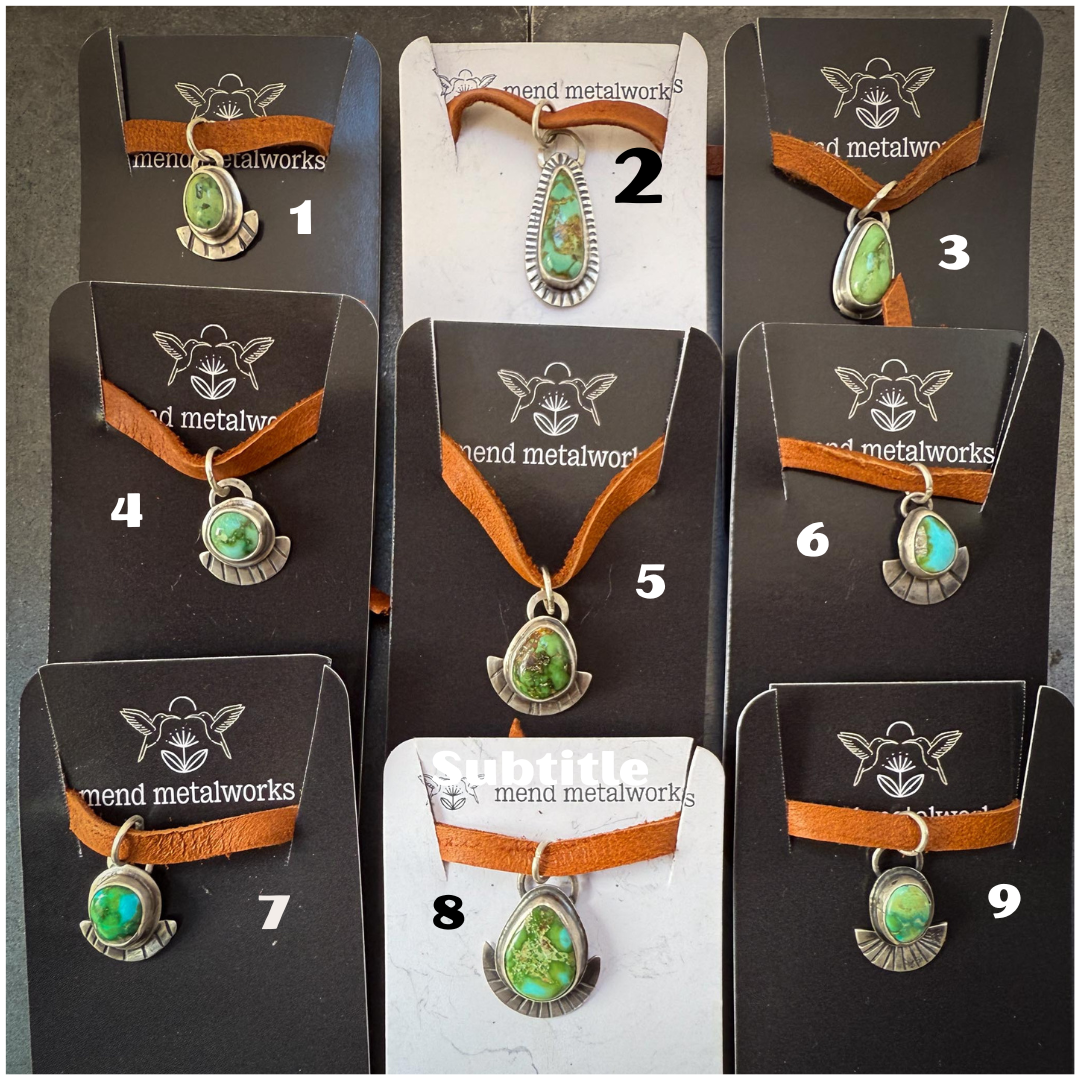 Necklaces with green pendants on brown cord, displayed on cards with 'mend metalworks' branding.