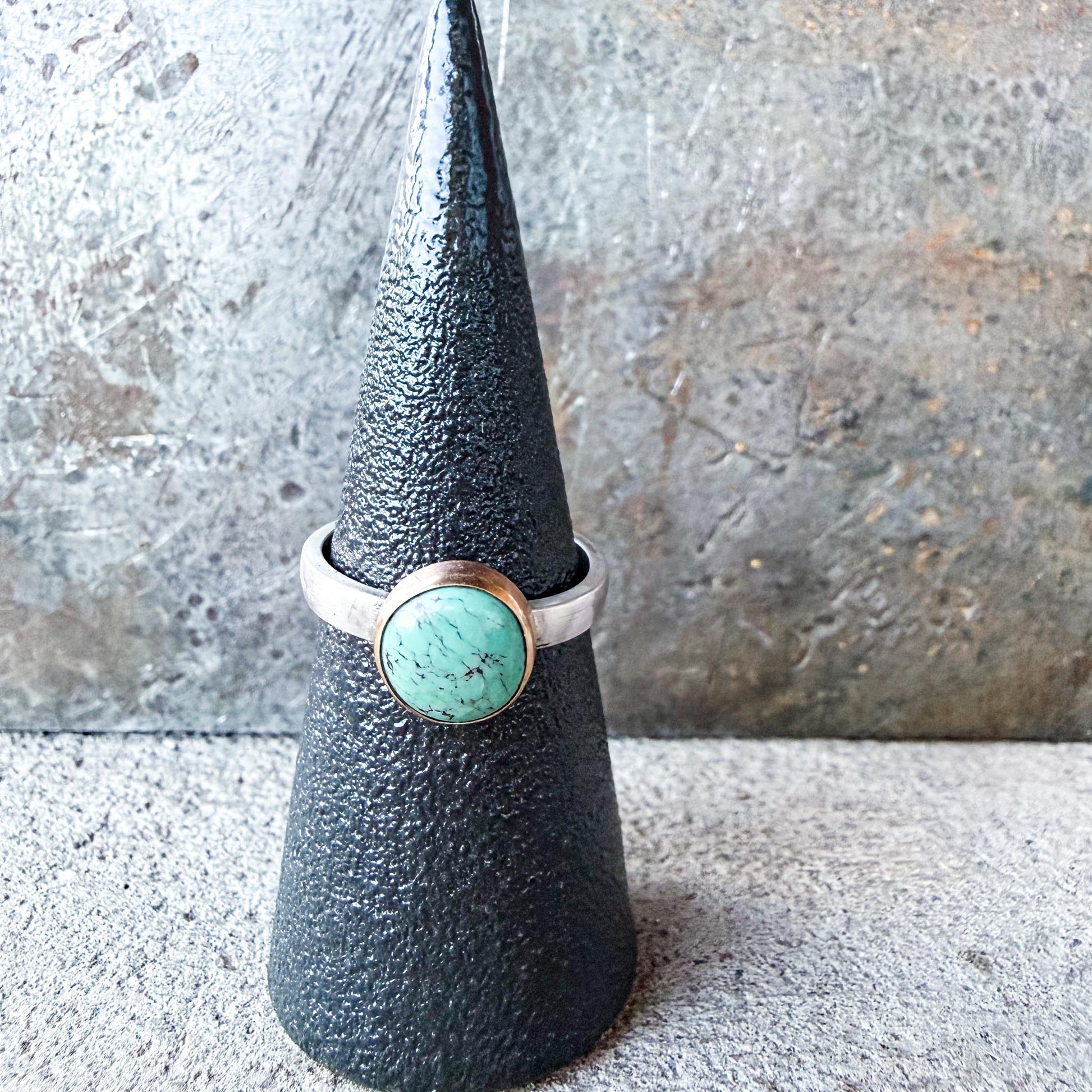 Silver ring with a turquoise stone gold-fill bezel and silver ring shank