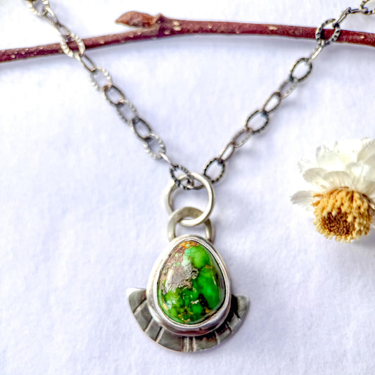 Necklace with a green pendant on a white background